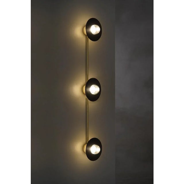 Alba triple wall light by contain dimensions: d15 x w100 x h11.5 cm materials: brass, 3d printed pla structure and optical...