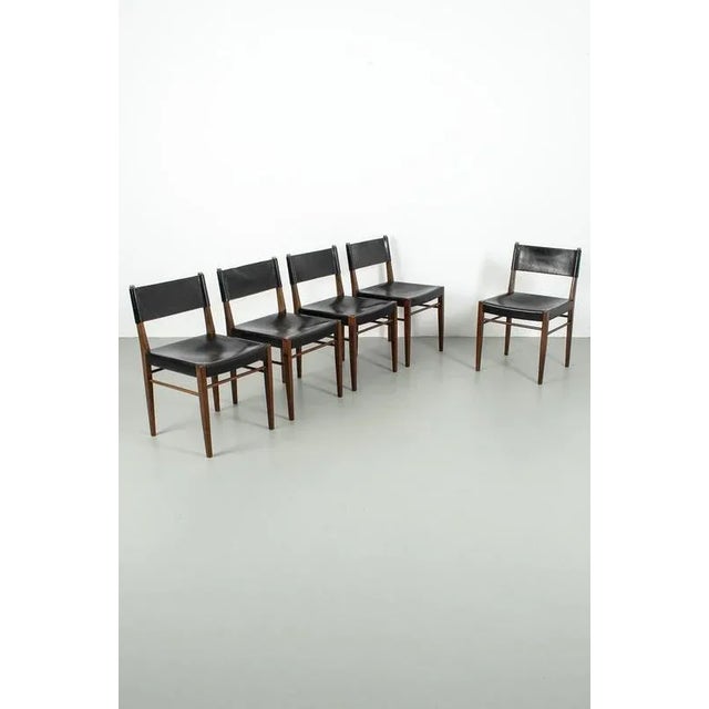 Set of 5 vintage chairs from the 60’s, upholstered with thick leather. Some seems were torn but we repaired them. The set...