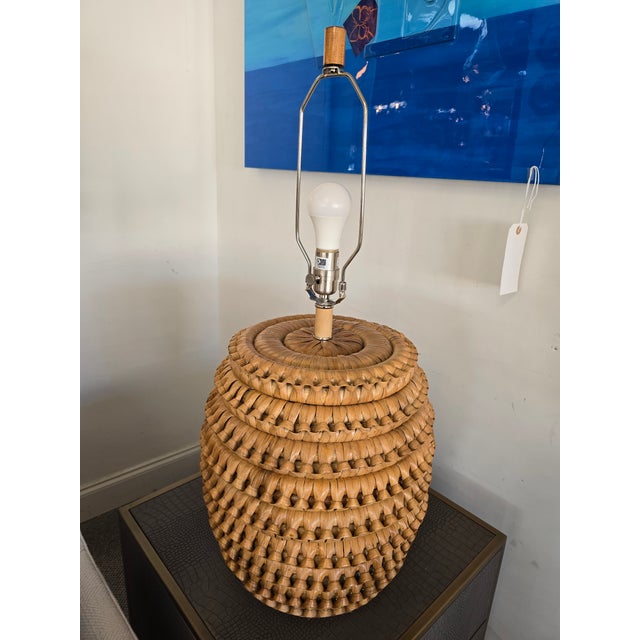 Rattan frame lamp with hand woven braided rattan peel in natural finish.