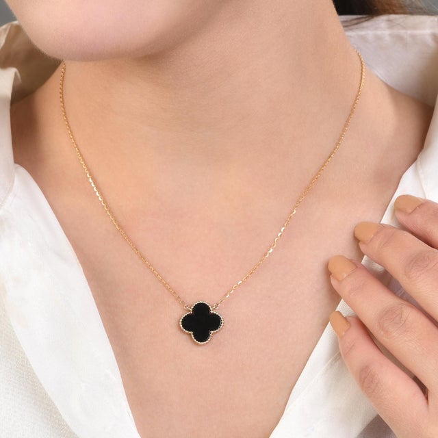 Black Onyx Clover Lucky Charm Pendant Chain Necklace in 14K gold studded with clover cut onyx. This stunning piece of...