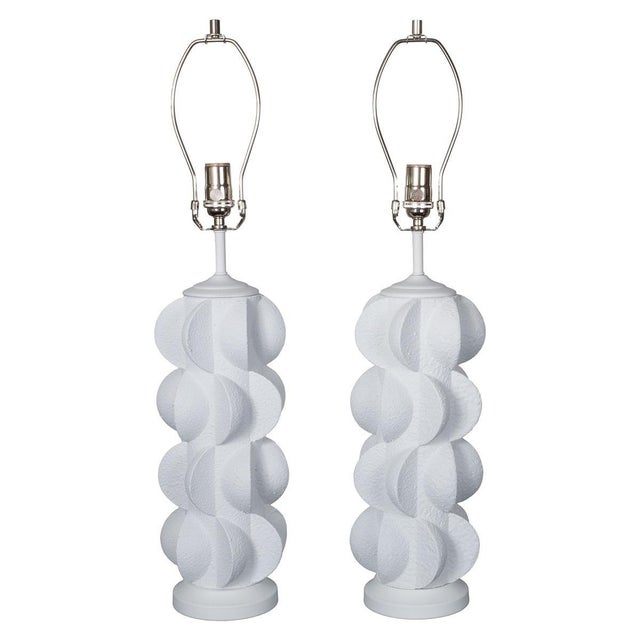 Pair of white composition table lamps with modern semi-circle motif.