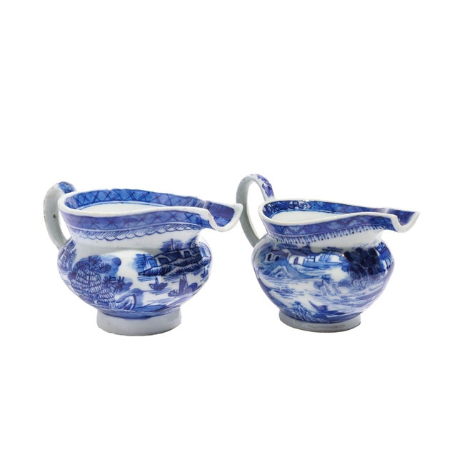 Matched pair of Chinese export porcelain pig snout creamers with applied loop handles. The body of the creamers are...