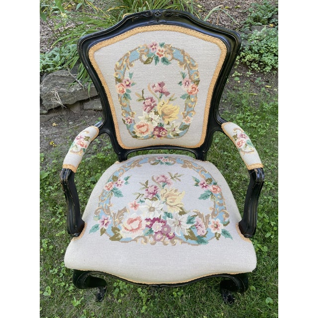 Antique Swedish armchair with ebonite black finish, cabriole legs, needlepoint upholstery on seat, back, and arm. The...