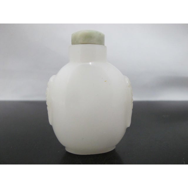 Chinese Chinese Carved Masks White Peking Glass Snuff Bottle With Green Top For Sale - Image 3 of 11