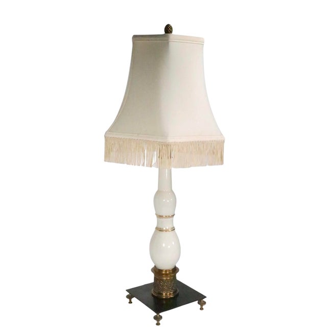 Pair of decorative table lamps by Stiffel. The lamps feature elegant Lenox porcelain bodies in white glaze finish with...