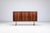 Unusual sideboard in rosewood with metal legs, Denmark 1960s. A distinctive Danish modern sideboard characterized by its...