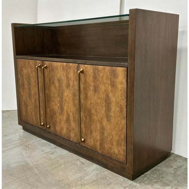 Original retail $2869, stylish Modern Wood and Cooper Three Door Bar Cabinet, four glass shelves, two wood shelves, one...