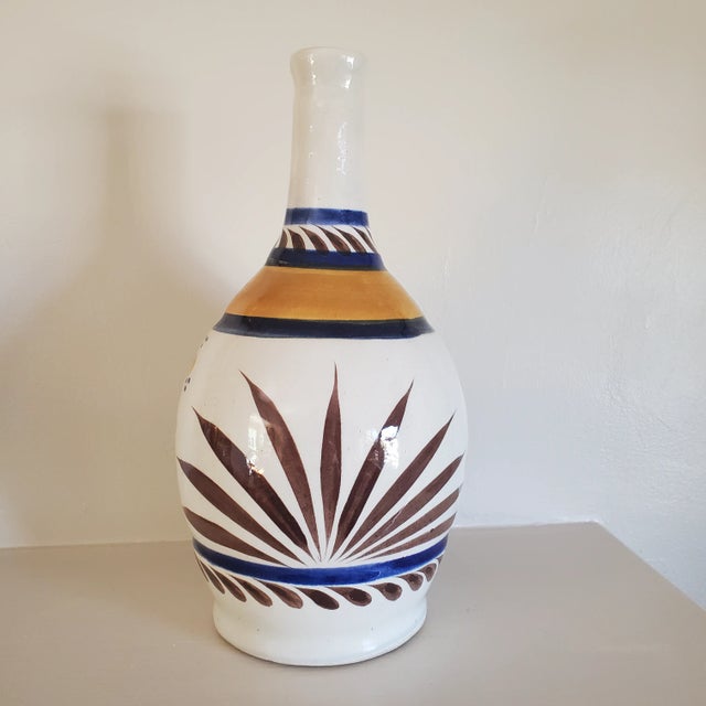 Lovely vintage handpainted Mexican vase. Unique colorway with bold floral and agave adornments. Simple and pretty it would...