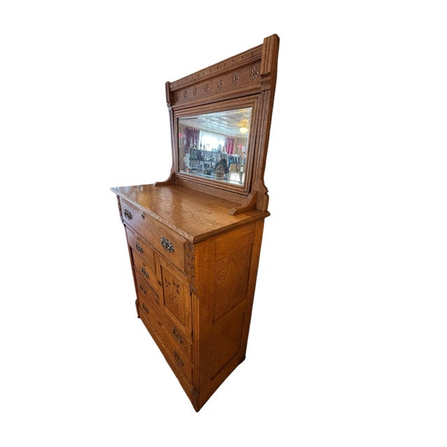 This Eastlake style Victorian early 1900s oak chest of drawers is a classic piece of furniture with a highboy design,...