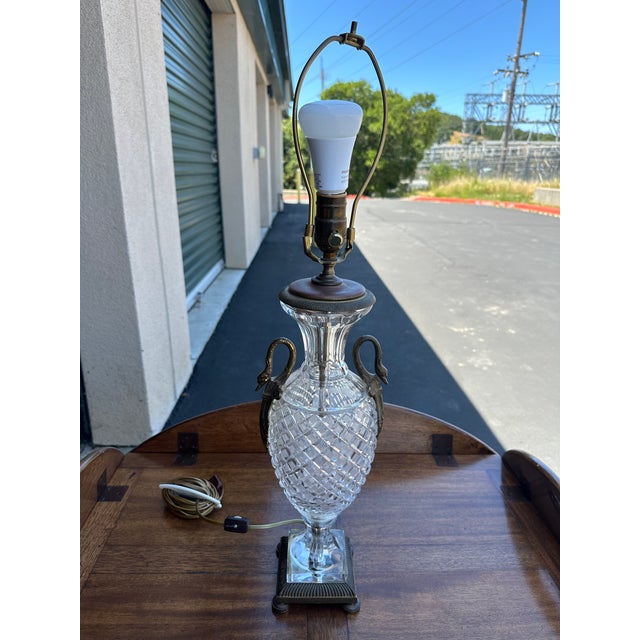 A Regency-style crystal lamp with ornate bronze mounts in the form of swan's necks. Elegant and detailed, with a 4.5"...