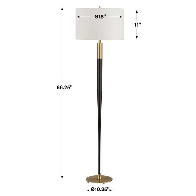The Tuxedo Floor Lamp features a tapered metal stem finished in a sleek satin black, accented with brass plated details....