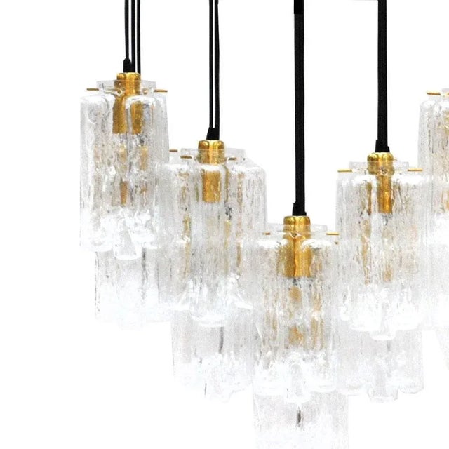 Contemporary Italian suspension lamp, composed of brass rectangular base, which are suspended six bulbs finish in hand...