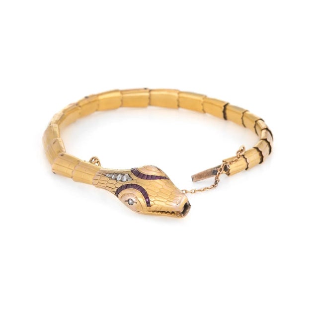 Finely detailed antique Edwardian era snake bracelet (circa 1907), crafted in 18k yellow gold. Rose cut diamonds graduate...