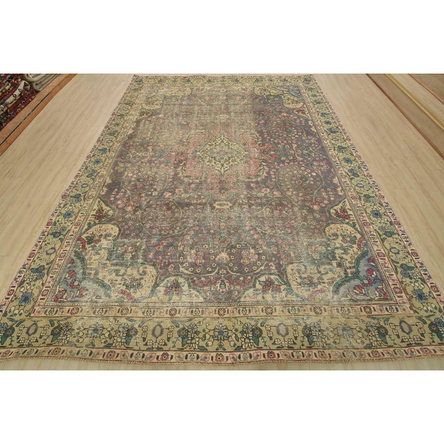 An authentic vintage traditional Tabriz rug hand-knotted with fine wool and natural dyes. This oriental rug features a...