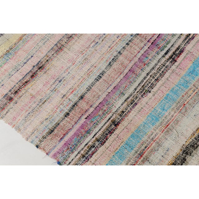 This is a vintage Turkish Oushak rug from the Mid 20th Century. The piece was hand-knotted.
