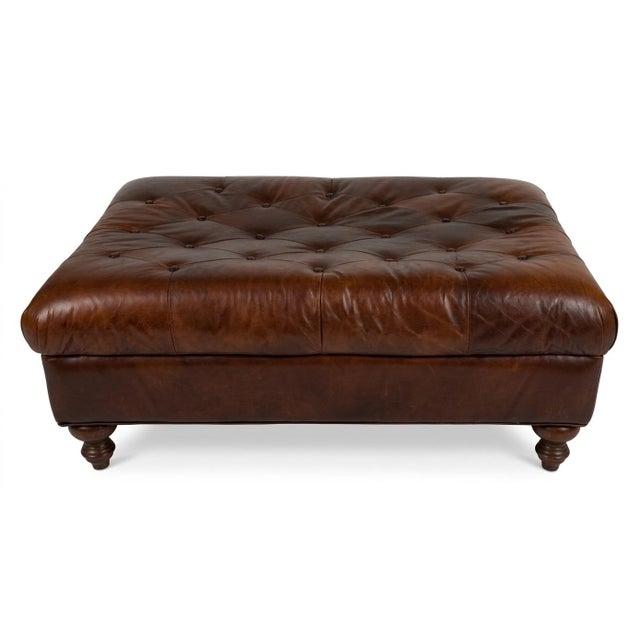 Vintage tufted leather ottoman. Classic chesterfield with turned legs and just the right amount of aged patina to make you...