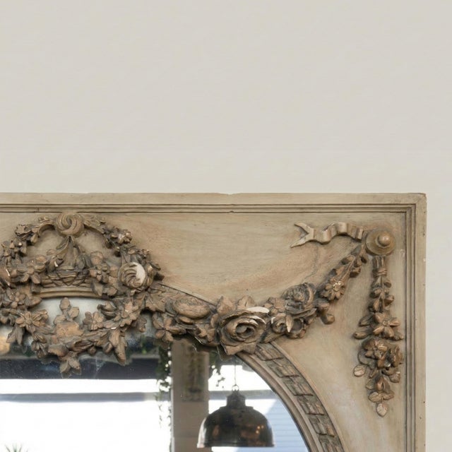 with its theatrical presence and rare refinement, this large overmantel mirror in cream lacquered wood with gray...