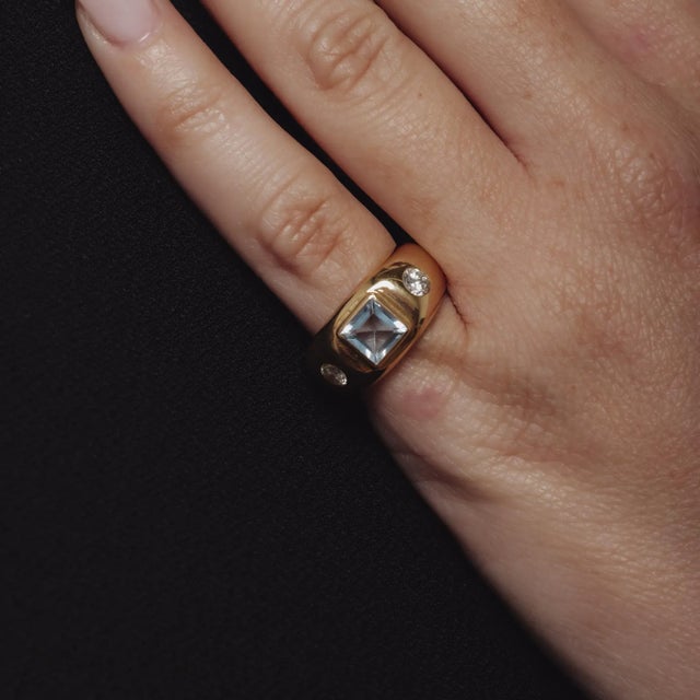 This vintage ring from the 1980’s showcases a serene square cut aquamarine of approximately .80 carats, its cool blue hue...