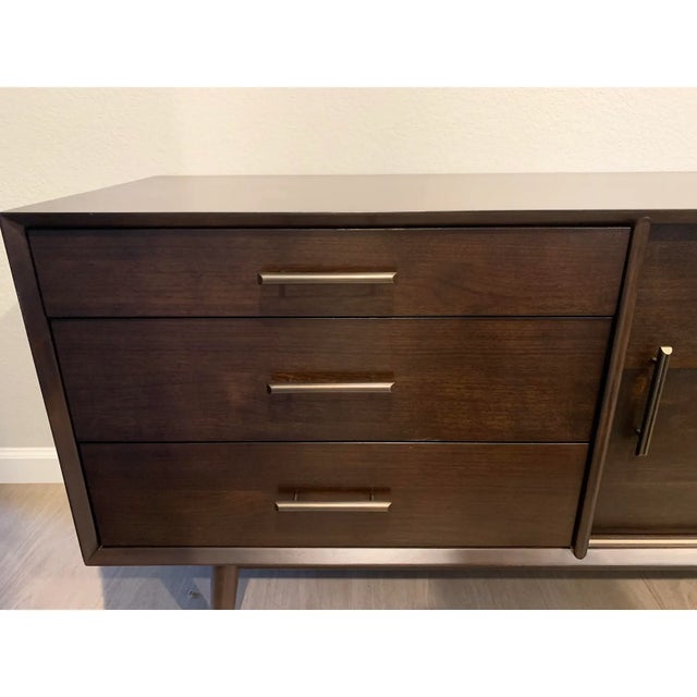 Console with details from iconic '50s and '60s furniture design. Fitted with drawers and a spacious cabinet with a shelf...