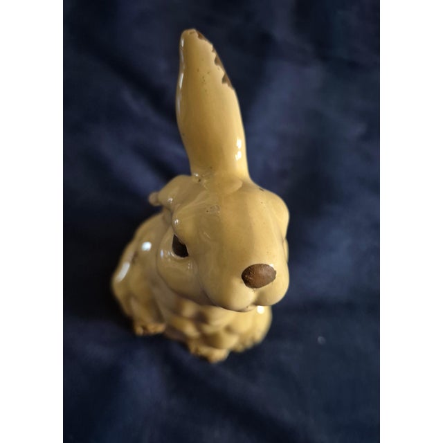 Add a touch of rustic charm to your shelves or spring tablescapes with this delightful vintage-inspired folk art rabbit...