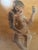 A distinctive mid-century modern figurative artwork dated 1958, featuring a stylized seated figure rendered in an...
