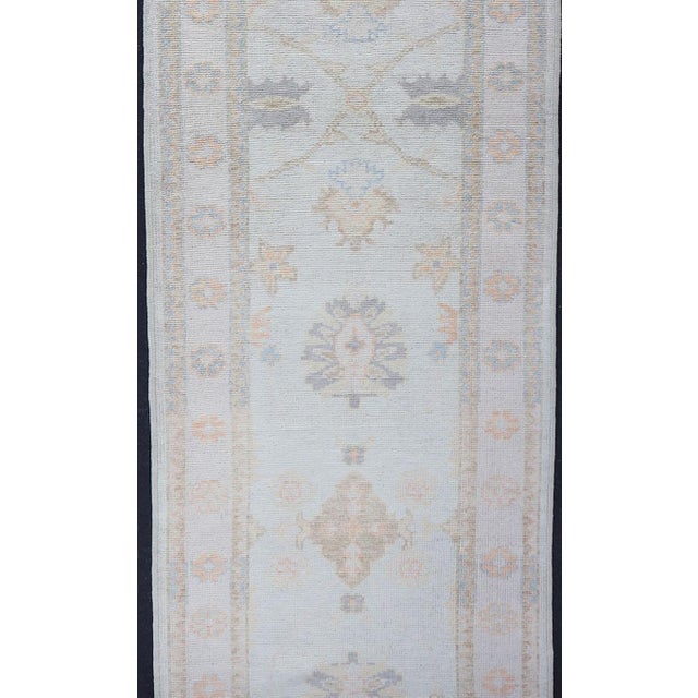 Measures: 2'10 x 21'0 Long Turkish Oushak Runner in Ivory with Faded Green and Terracotta 2'10 x 21'0. Keivan Woven Arts....