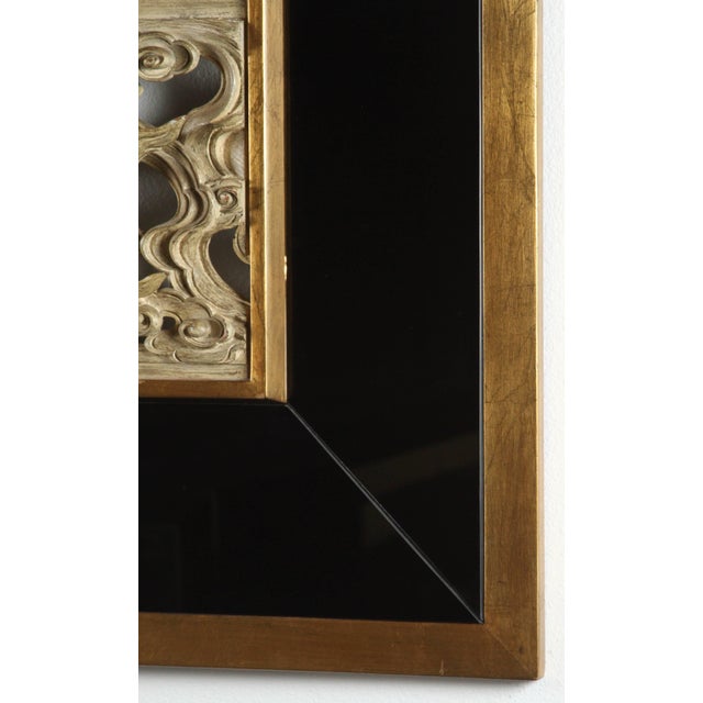 Beautiful and finely detailed oriental carving of a bird in the clouds. The frame is black mirror and gilded wood.