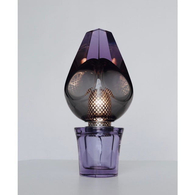 The design of this lamp is attributed to Flavio Poli. It is crafted from thick Murano glass with a graduated mauve...