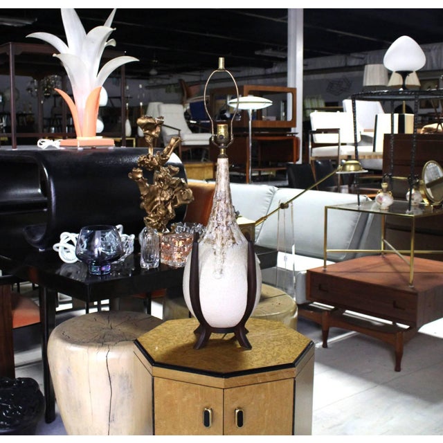 Dripping vase pattern ceramic table lamp on oiled walnut base.