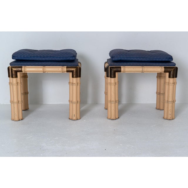 A pair of stylish mid-century modern faux bamboo and upholstered benches in the style of Billy Baldwin. Each wooden leg is...