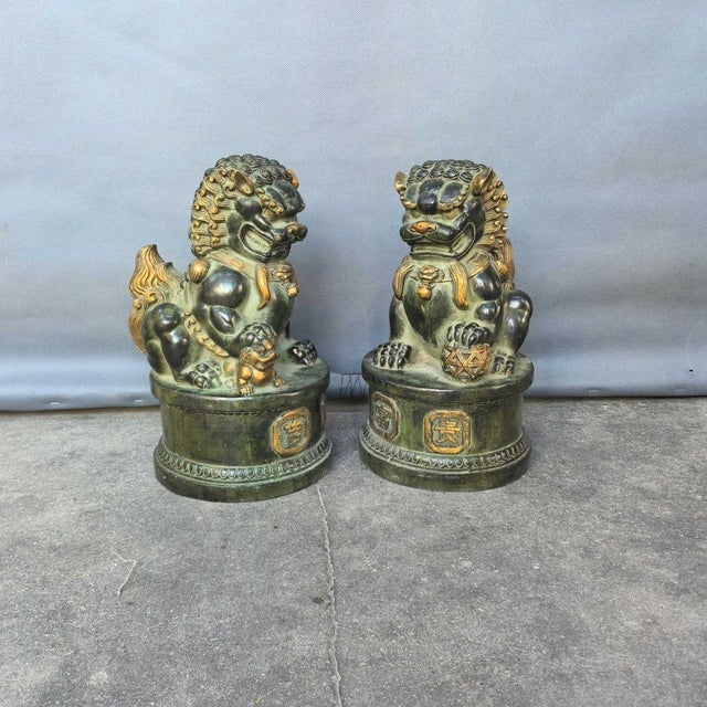 A commanding and magnificent pair of vintage Chinese guardian lions (commonly known as Foo Dogs), sourced from a private...