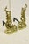 Lovely pair of cast brass andirons in the French Rococo style. Features a classic asymmetrical leaf and volute motif...