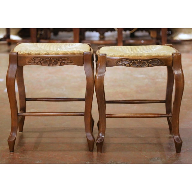 This elegant pair of Louis XV style stools brings warmth, texture, and French provincial charm to any interior. Crafted in...
