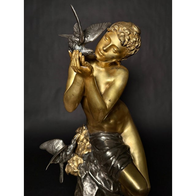Mathurin Moreau (French, 1822-1912) rare gilt and silvered bronze of a young maiden seated on a rock with three birds,...