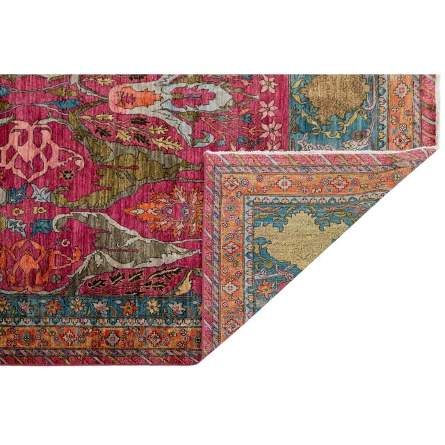 A striking modern interpretation of Persian Bidjar design, this handwoven wool rug features a vivid magenta field with...