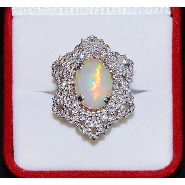 Stunning 18K solid gold 7.56CTS natural diamond and untreated opal dome ring. This ring features a huge 6.69CT natural...