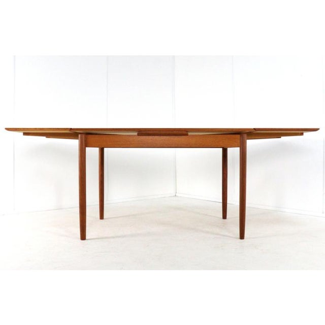 Attractive extendable teak dining table. The table can be extended using an ingenious system. Underneath the tabletop,...