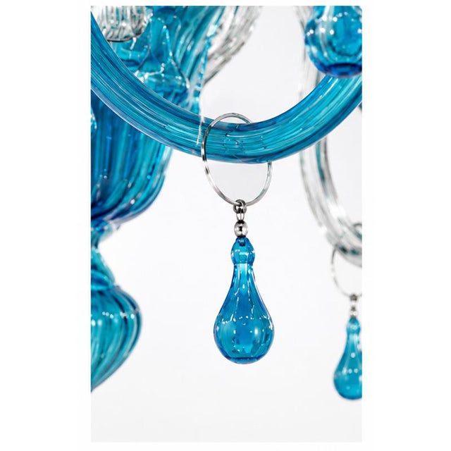 Spectacular Venetian chandelier, handcrafted from Murano glass, featuring a refined combination of clear crystal glass and...