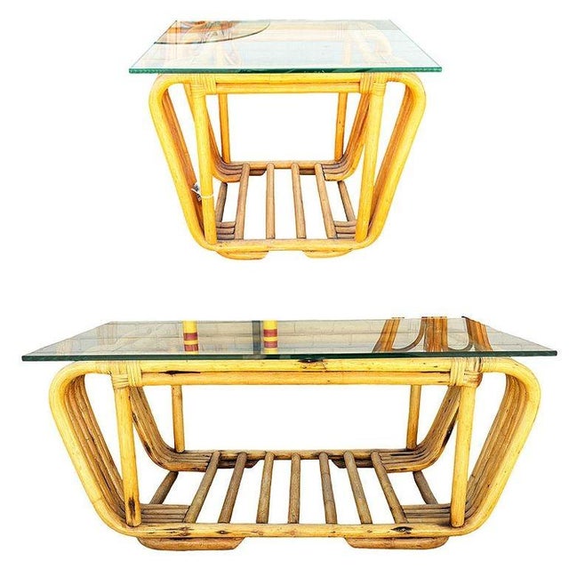 This beautifully restored mid-century floating glass top rattan coffee table and side table set. Each table features a...