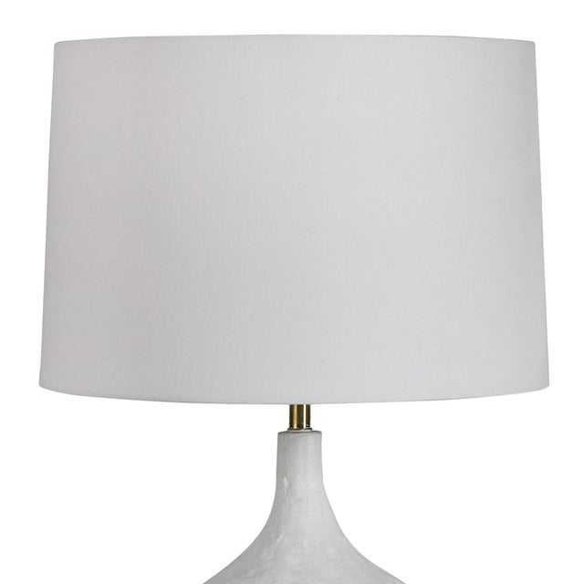 Inspired by a paper maché bowl, this versatile lamp is at home in a variety of spaces. Complex curves, paired with a matte...