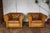 Beautiful vintage pair of English Chesterfield club chairs in rich honey-brown distressed leather. Featuring classic...