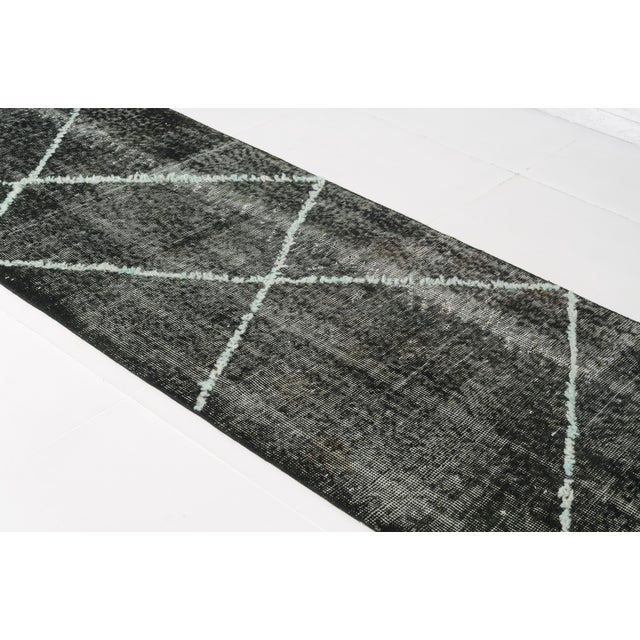 This is a vintage Turkish Oushak rug from the Mid 20th Century. The piece was hand-knotted.