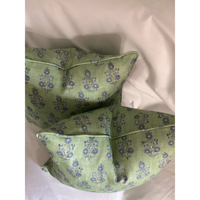 The Poppy Sprig fabric features a floral upholstery pattern with blue poppies and light blue foliage on a green...