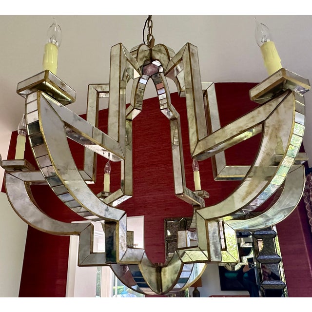 Geometric frame covered in antiqued mirror panels with antique brass finishes. This piece blends multiple design...