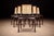 A set of six dining chairs produced in the 1960s, crafted in solid Brazilian rosewood with woven cane seats and backs. The...