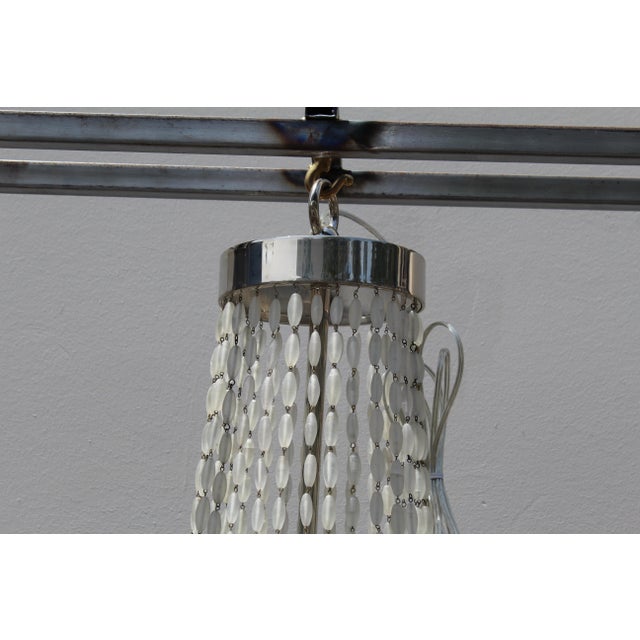 Custom designed by a popular designer in Los Angeles . Custom manufactured in a drapery design of Frosted Glass beads ....