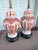 This pair of vintage porcelain ginger jar table lamps feature a classic 1950s design with intricate red-orange floral...