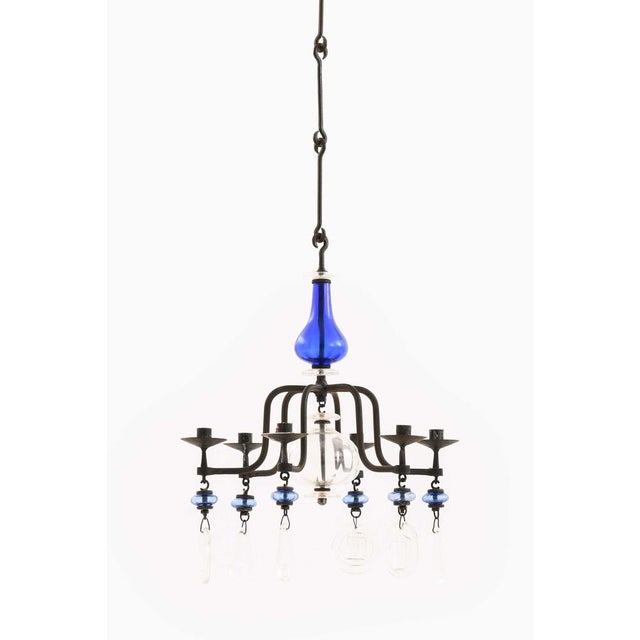 This rare hanging candelabra, designed by Erik Höglund and produced by Boda Glasbruk in Sweden, is a powerful expression...