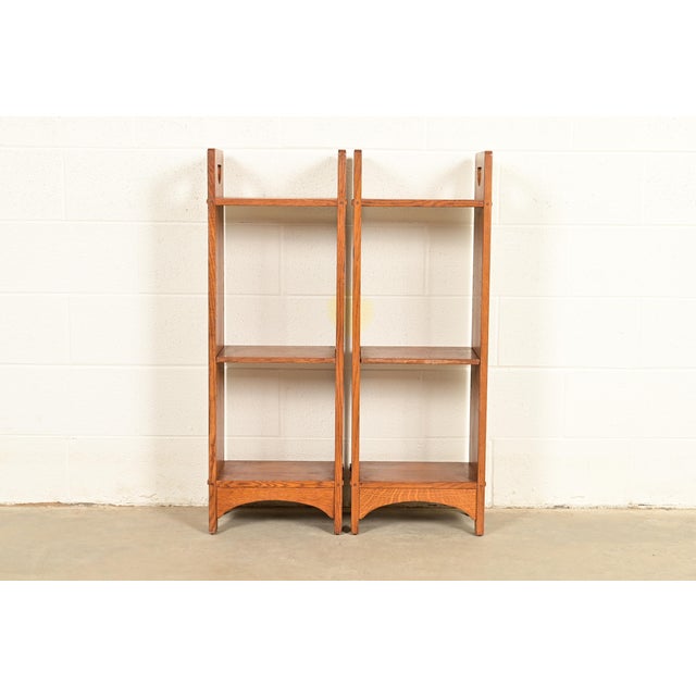 An exceptional pair of Mission or Arts & Crafts style solid oak cutout bookcases By L. & J.G. Stickley USA, Circa Early...
