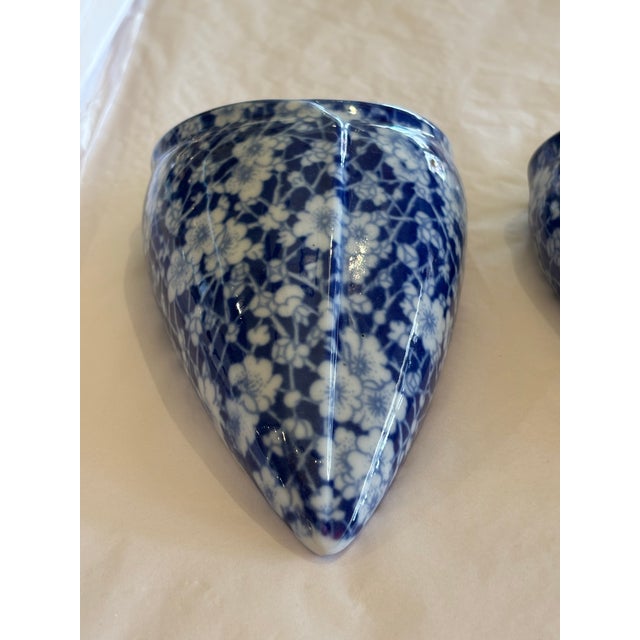 Sweet pair of blue and white wall pockets with integrated hanging hole. Floral design. No chips or cracks.
